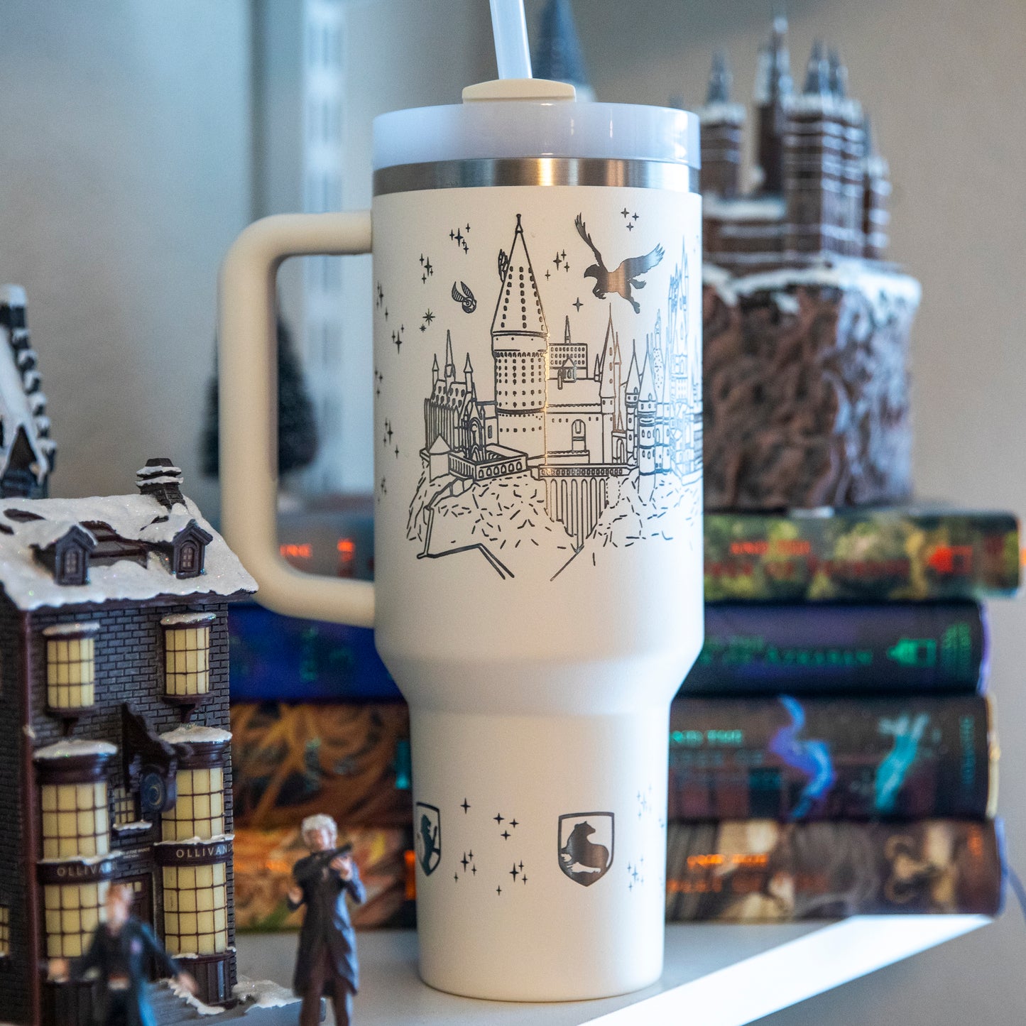 a harry potter travel mug sitting on top of a shelf