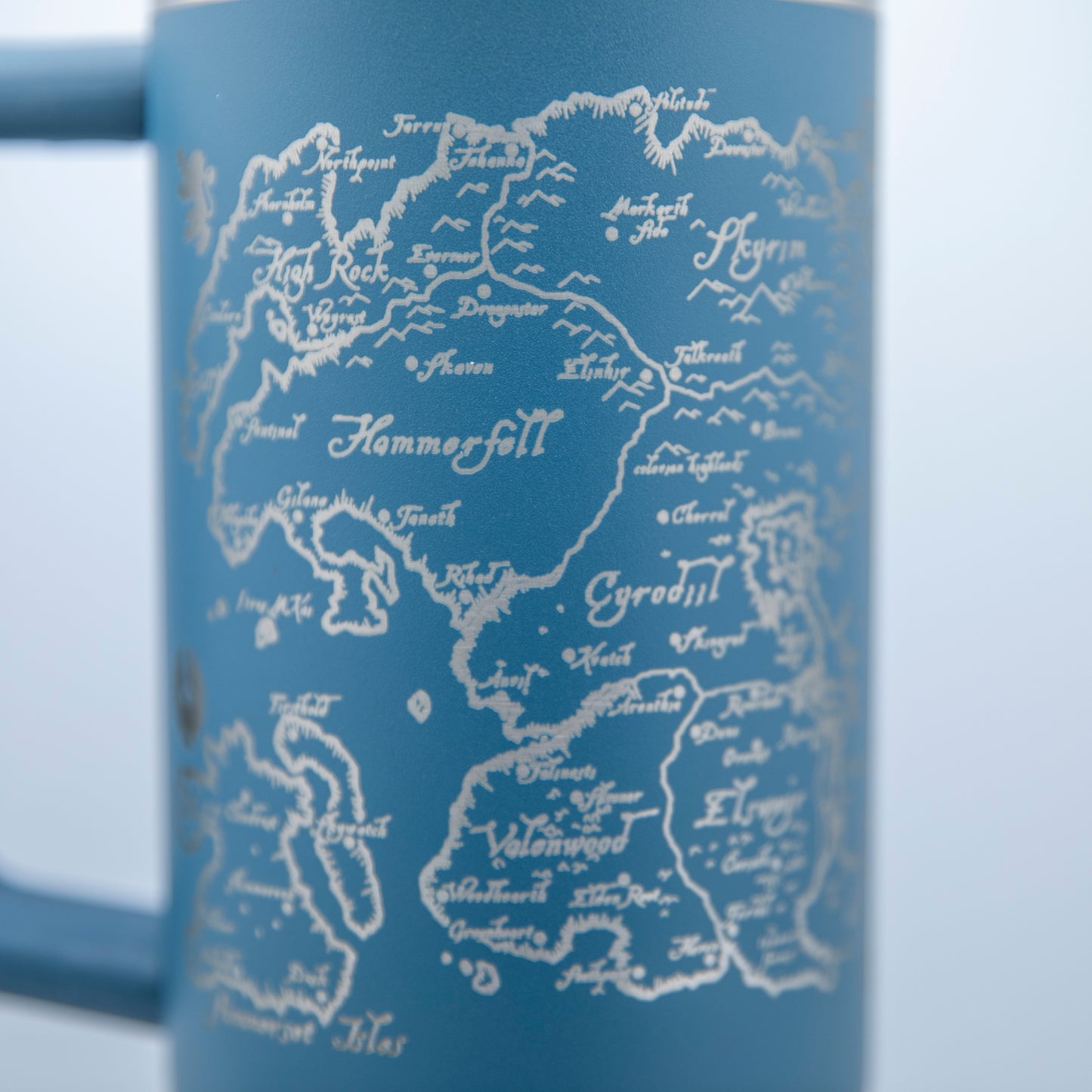 a blue coffee mug with a map of the world on it