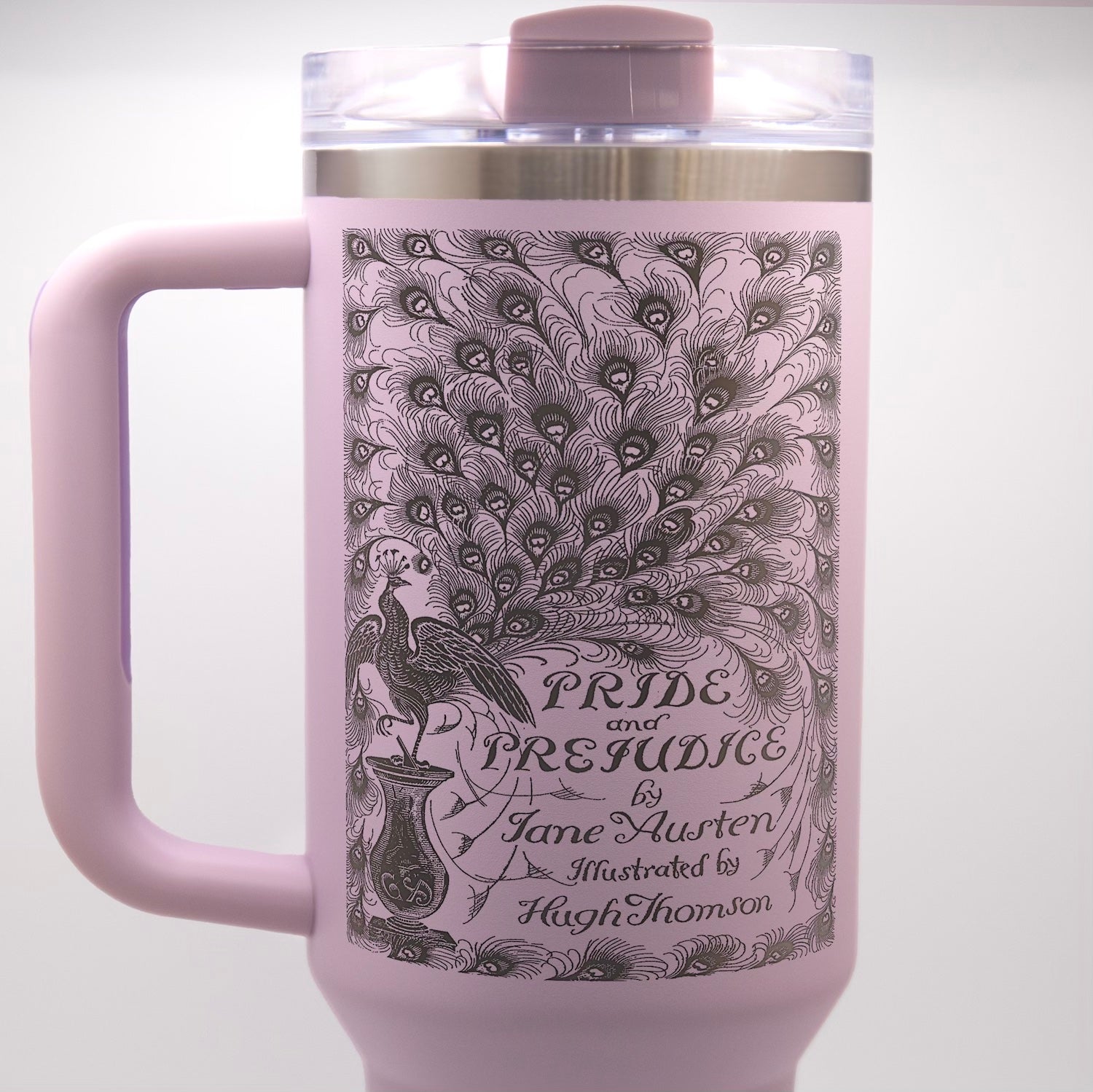 a pink coffee mug with a picture of a peacock on it