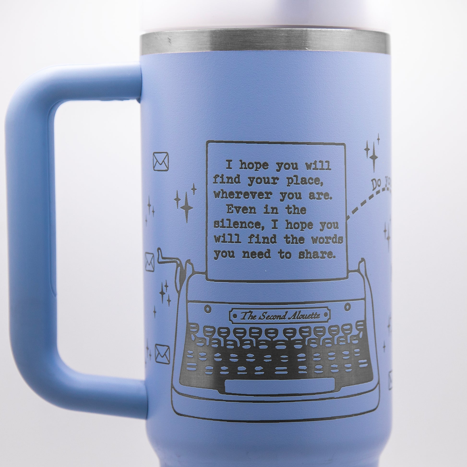 a blue coffee mug with a picture of a typewriter on it