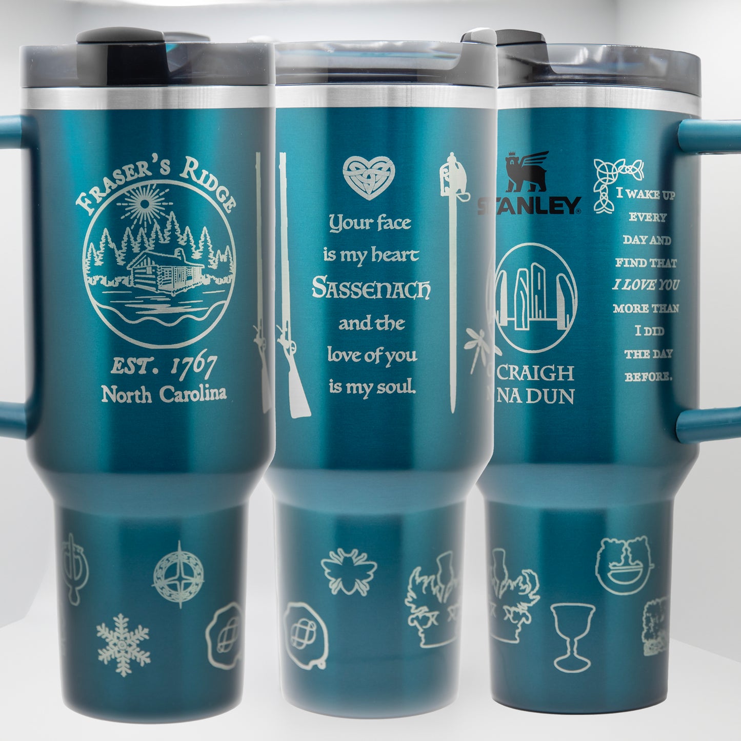 three travel mugs with different designs on them