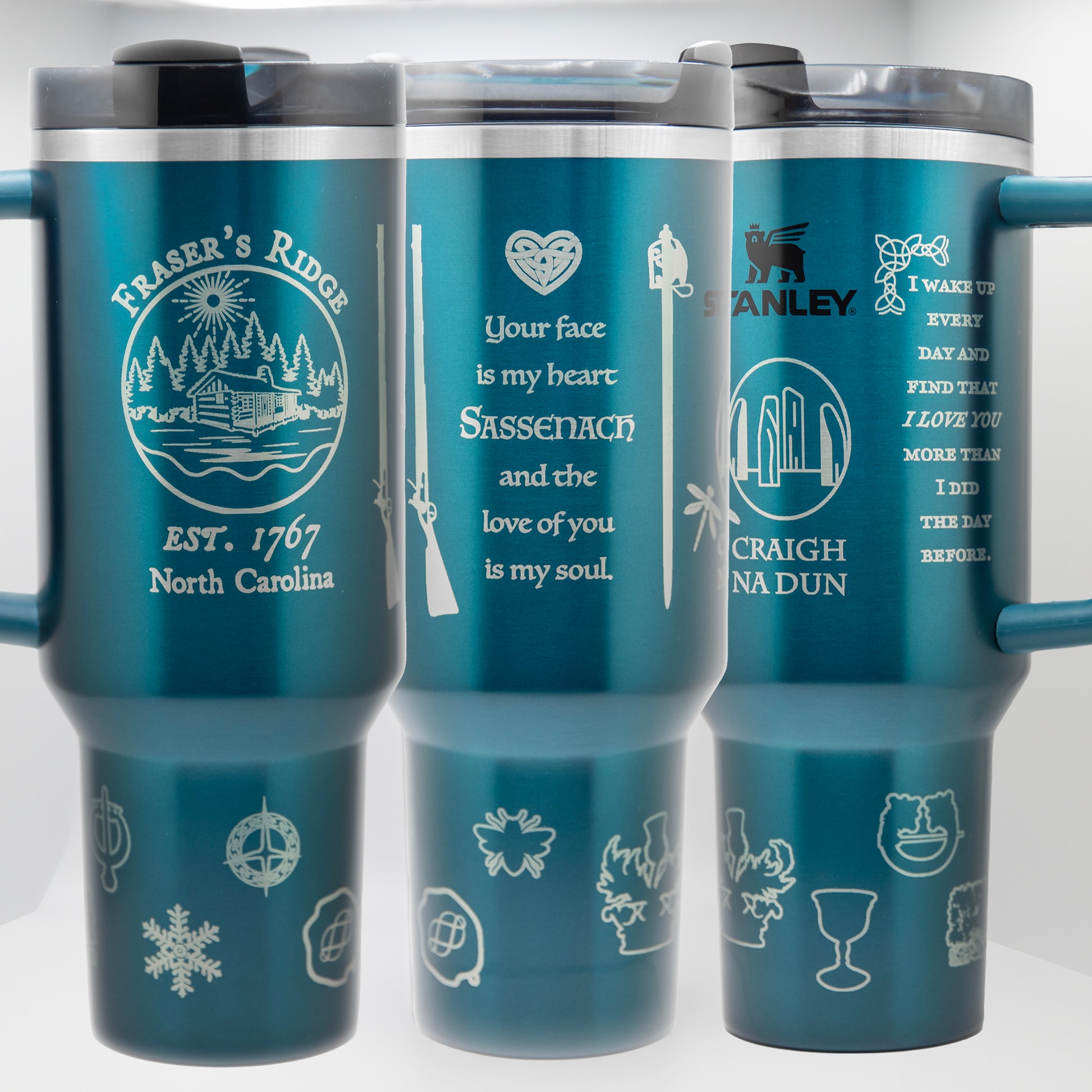 three travel mugs with different designs on them