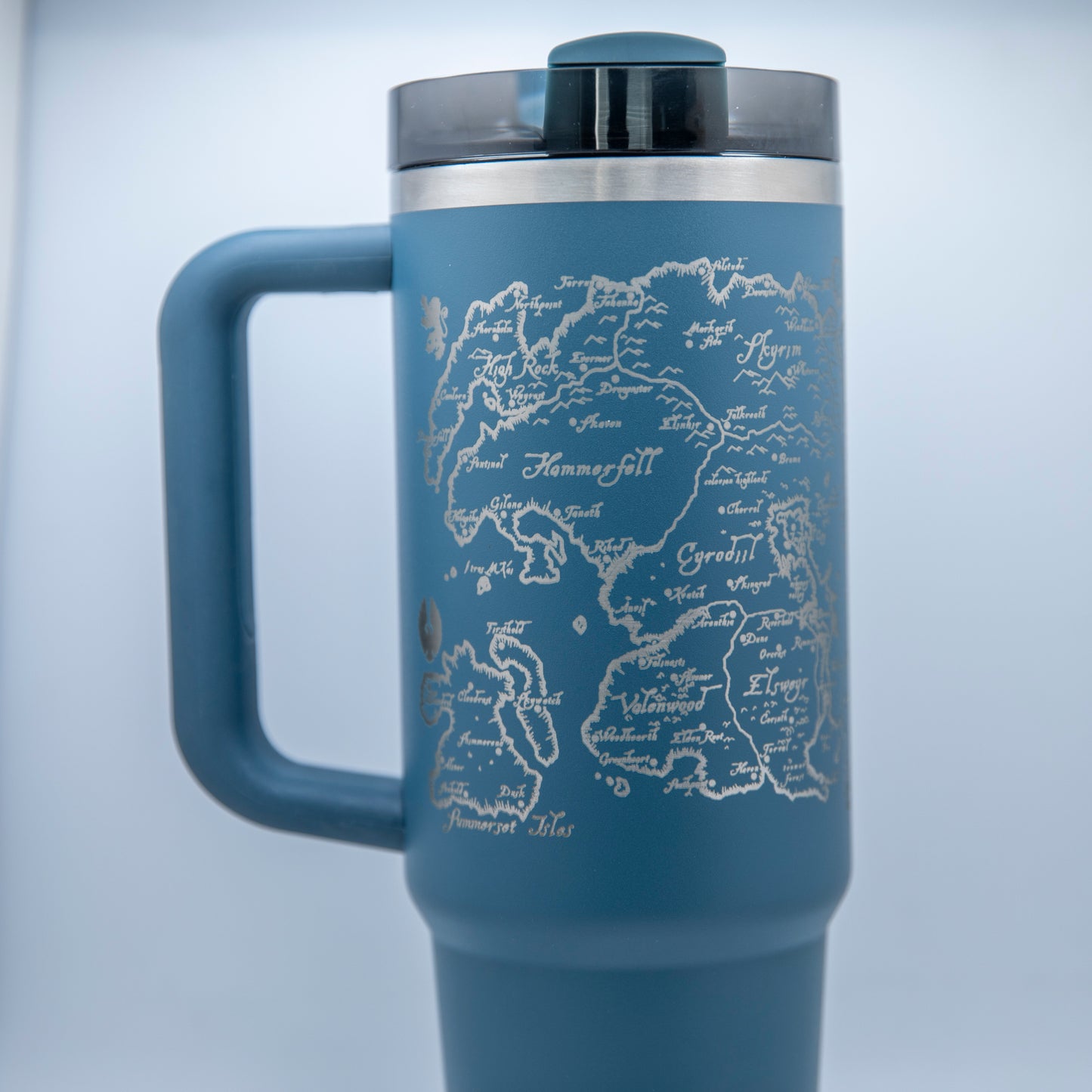 a blue travel mug with a map of the world on it