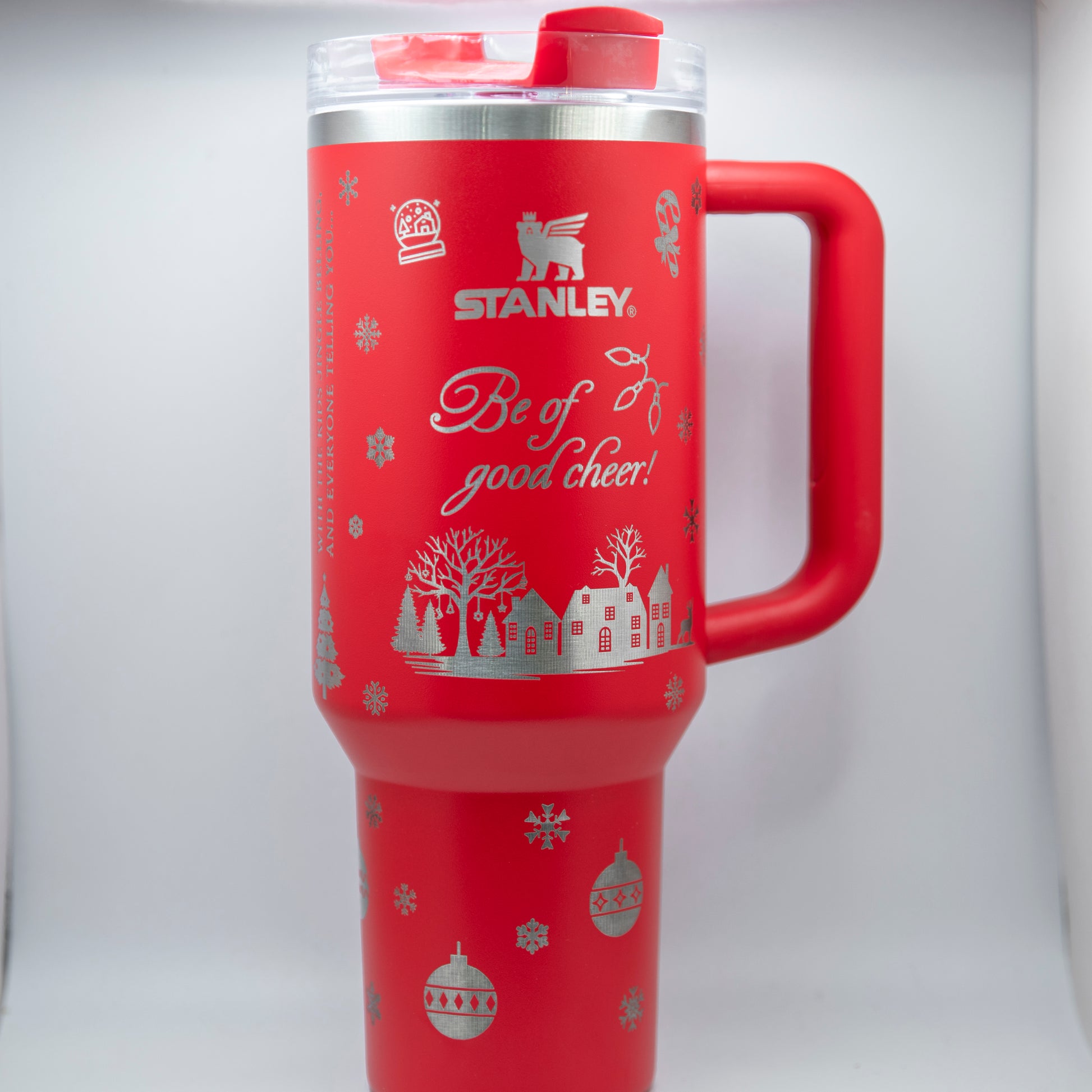 a red travel mug with a red handle