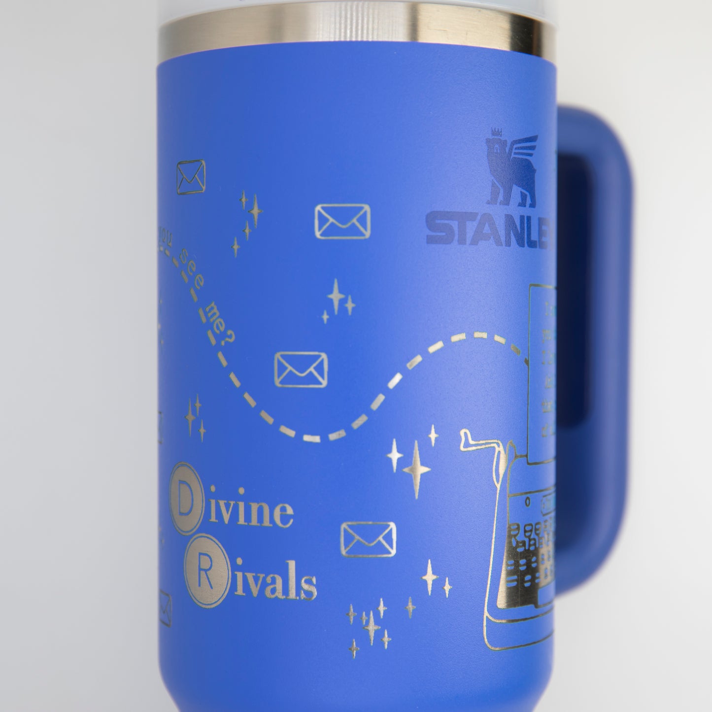 a blue travel mug is hanging on a wall