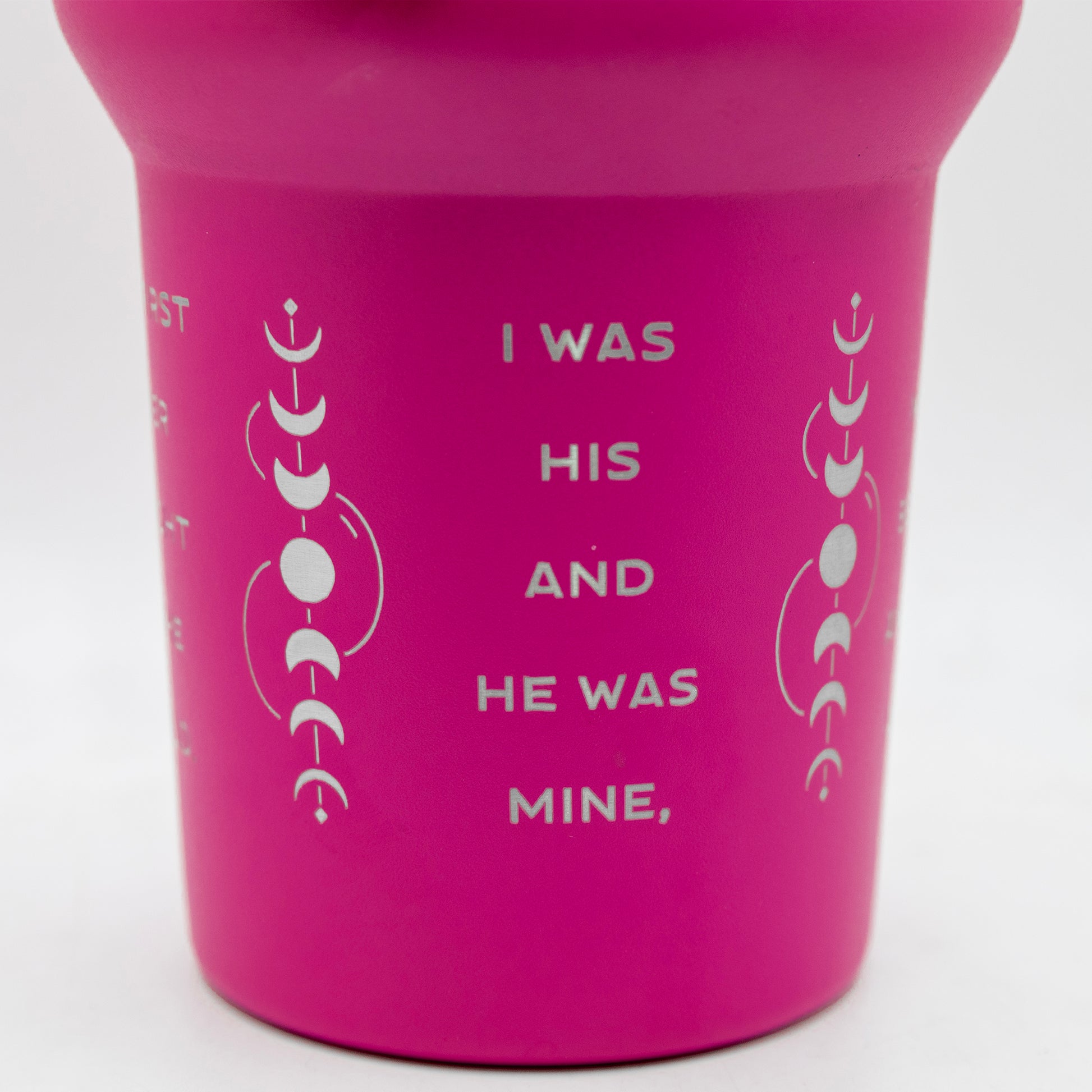 a pink cup with white writing on it