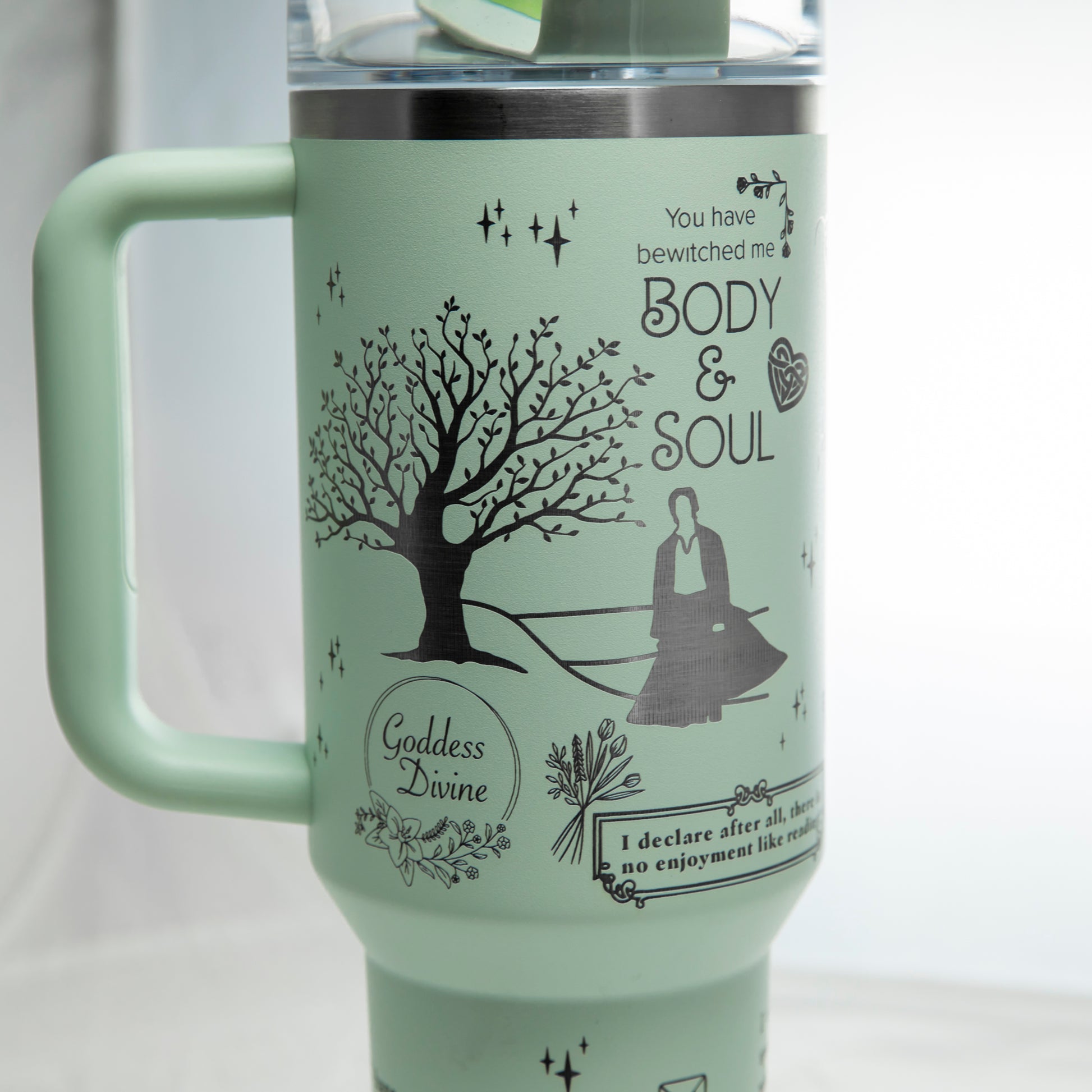 a travel mug with a picture of a tree on it