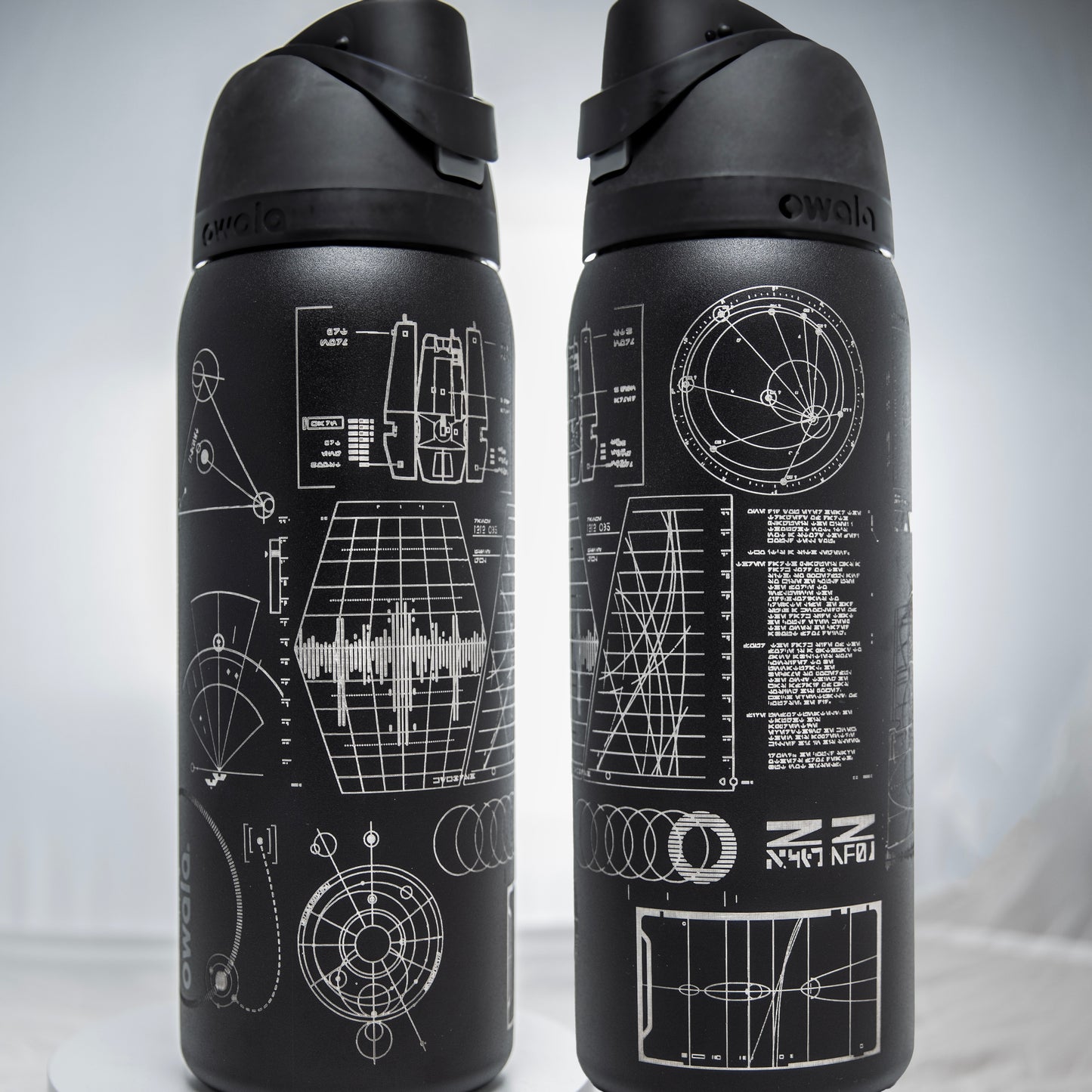 a couple of black water bottles sitting on top of a table