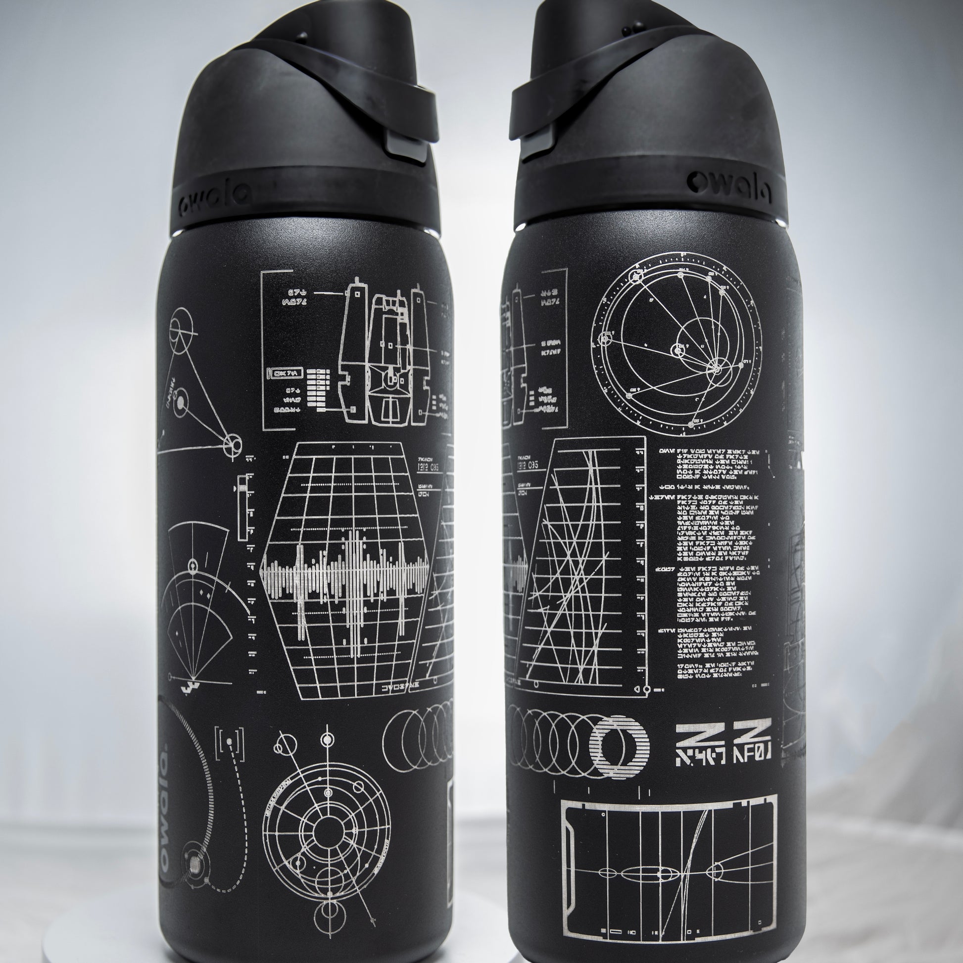 a couple of black water bottles sitting on top of a table