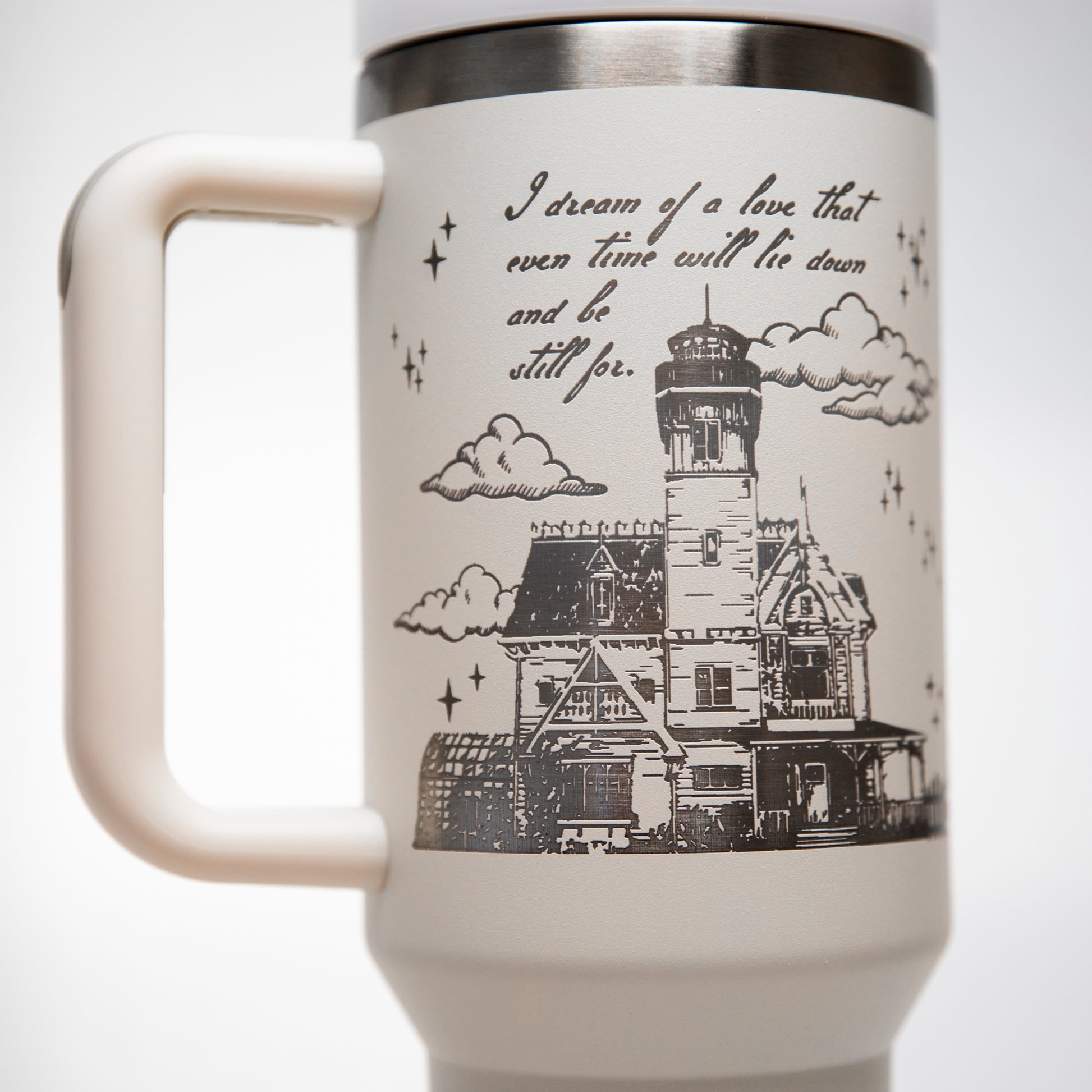 a white coffee mug with a picture of a lighthouse on it