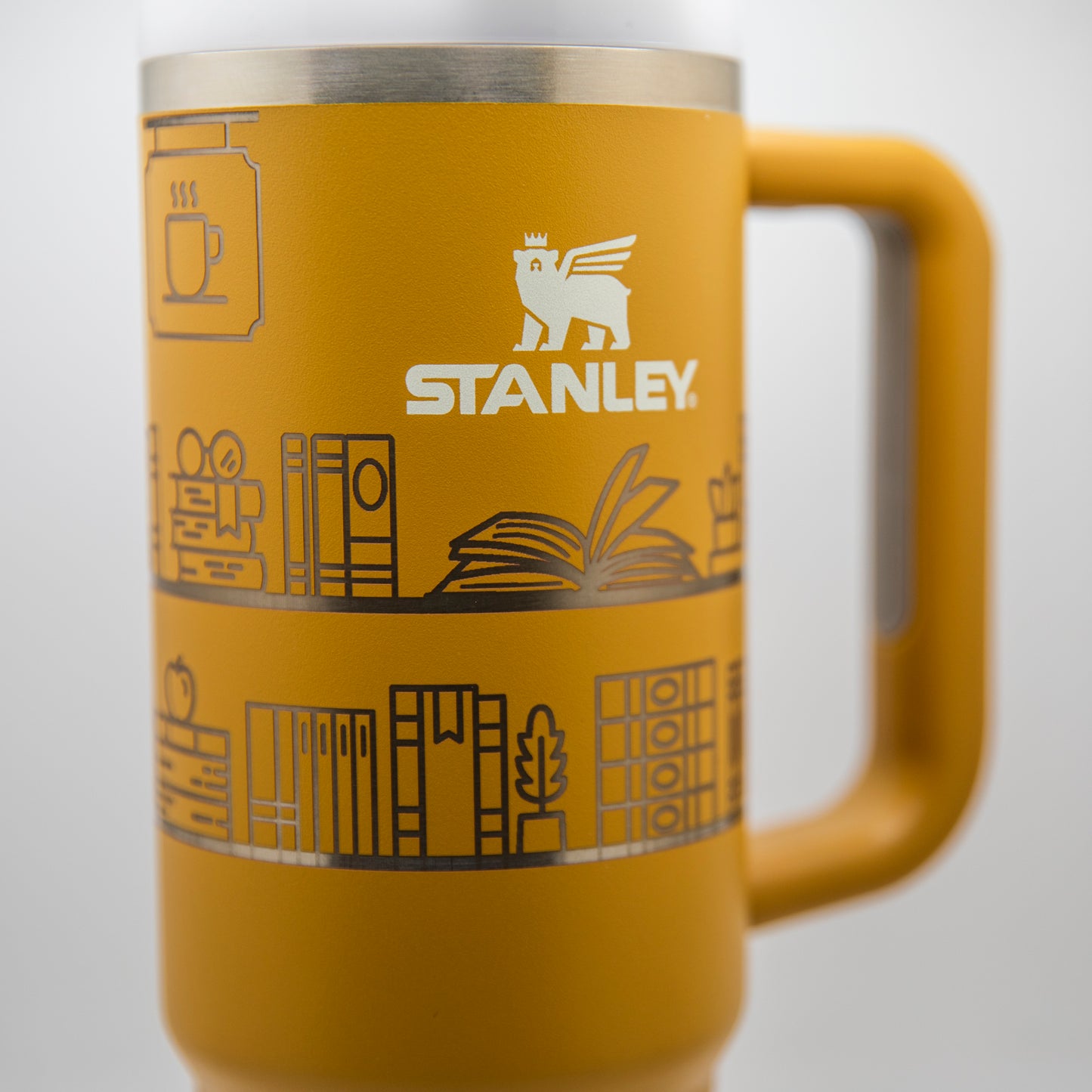 a yellow coffee mug with a picture of a book on it