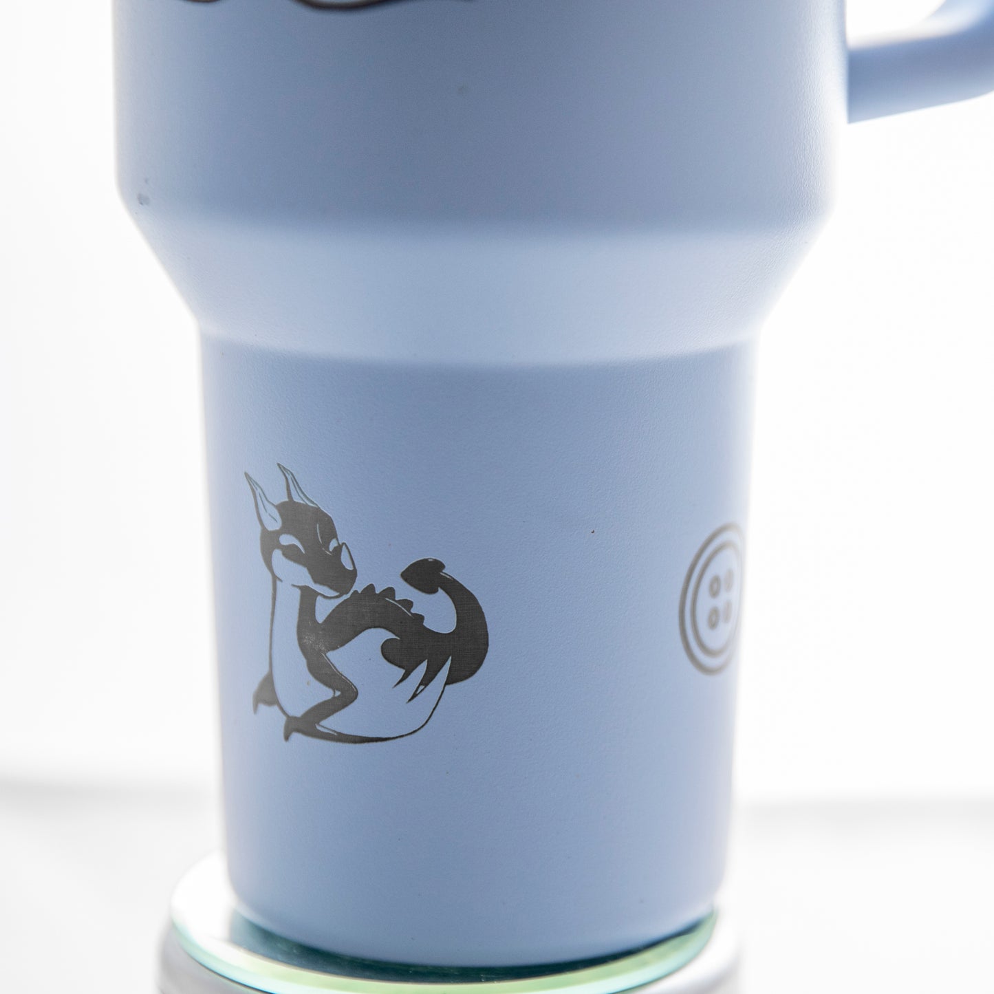 a blue travel mug with a black dragon on it