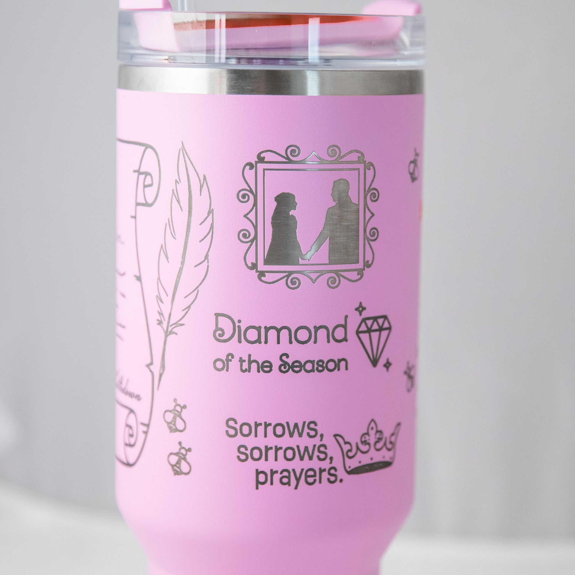 a pink travel mug with a picture of a man and a woman on it