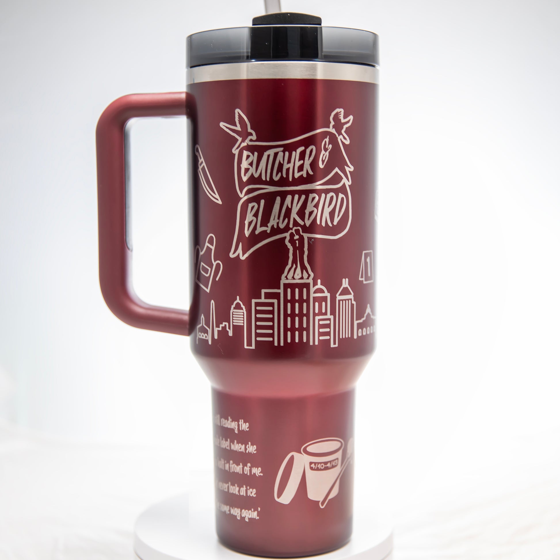 a red travel mug with a handle on a white background