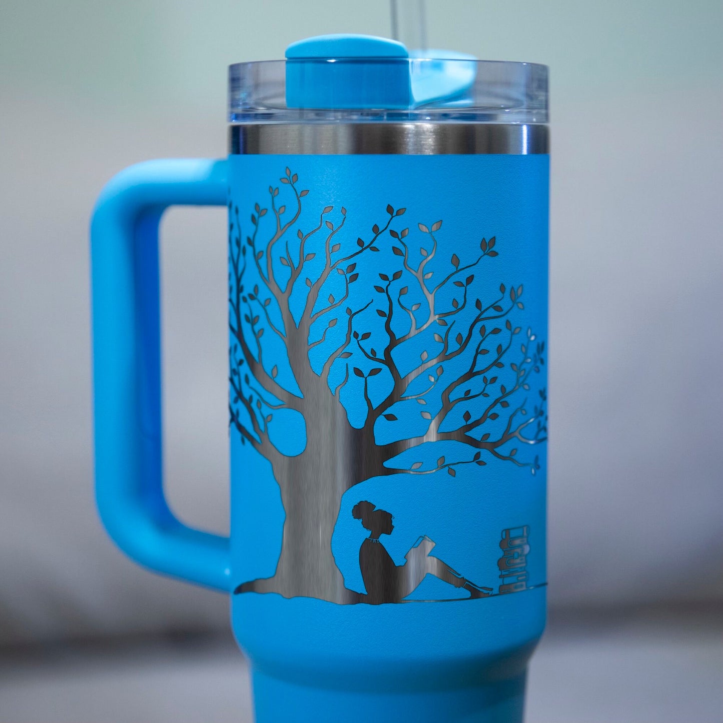 a blue coffee mug with a tree painted on it