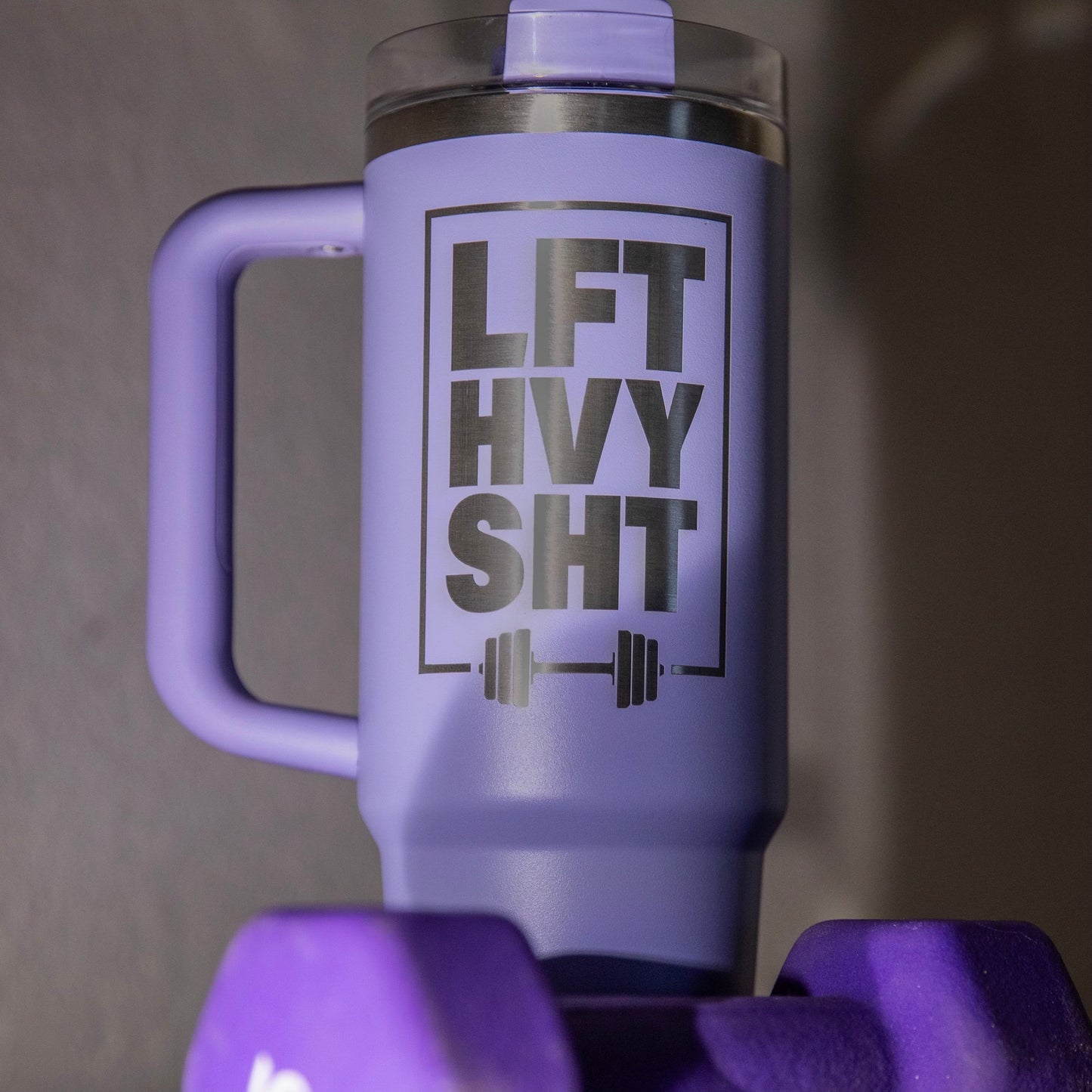 a purple mug with a purple handle and a purple dumbbell