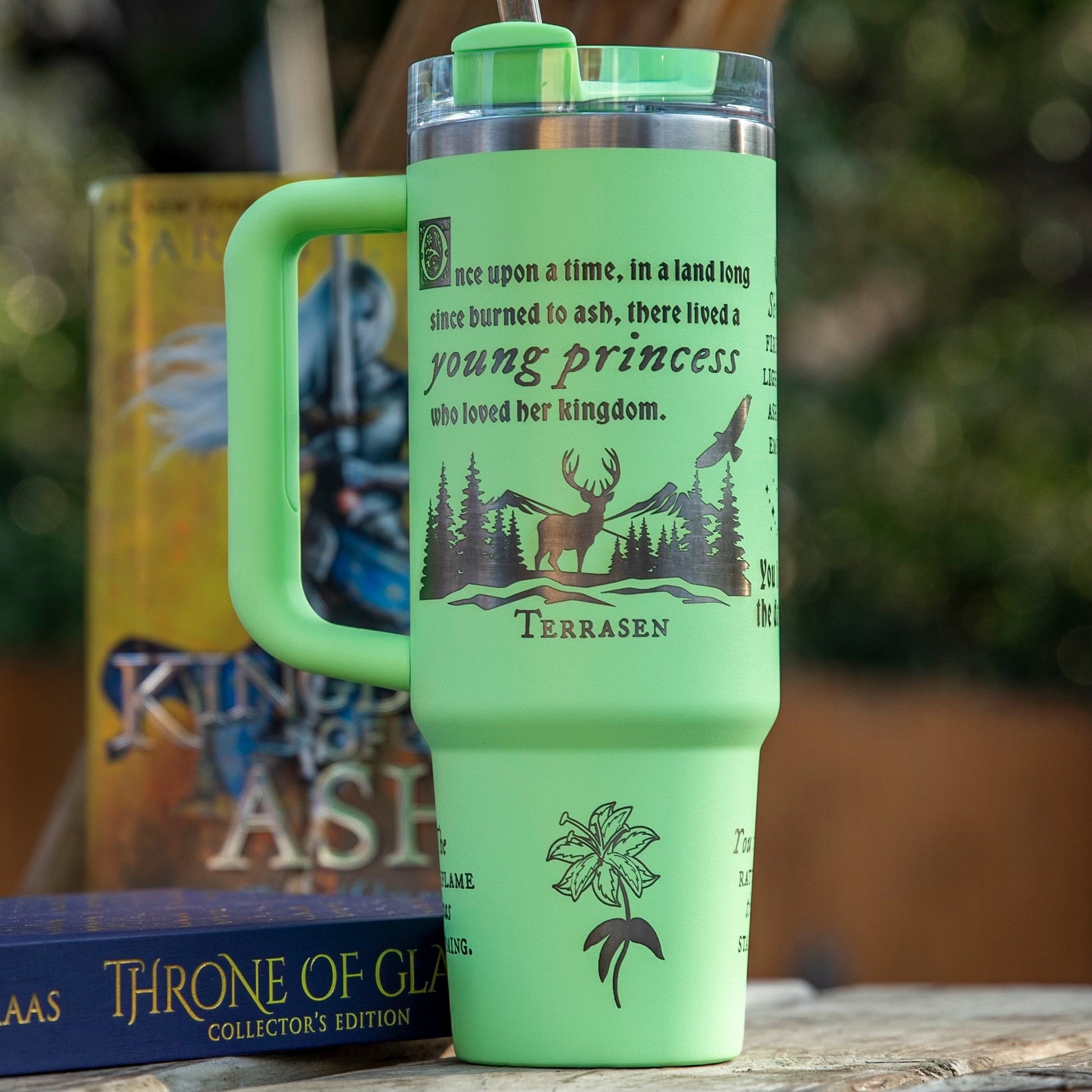 a green coffee cup sitting on top of a wooden table