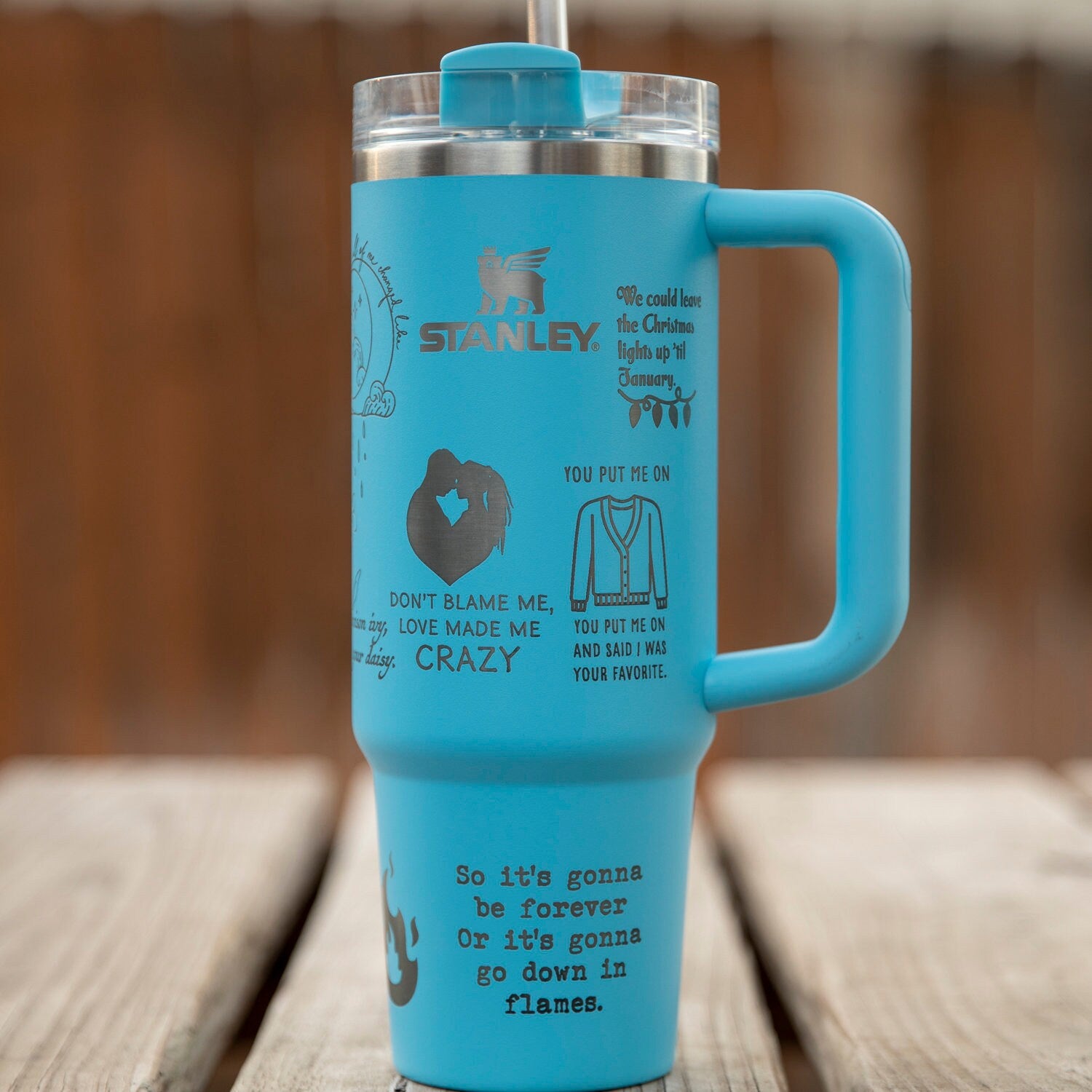 a blue travel mug sitting on top of a wooden table