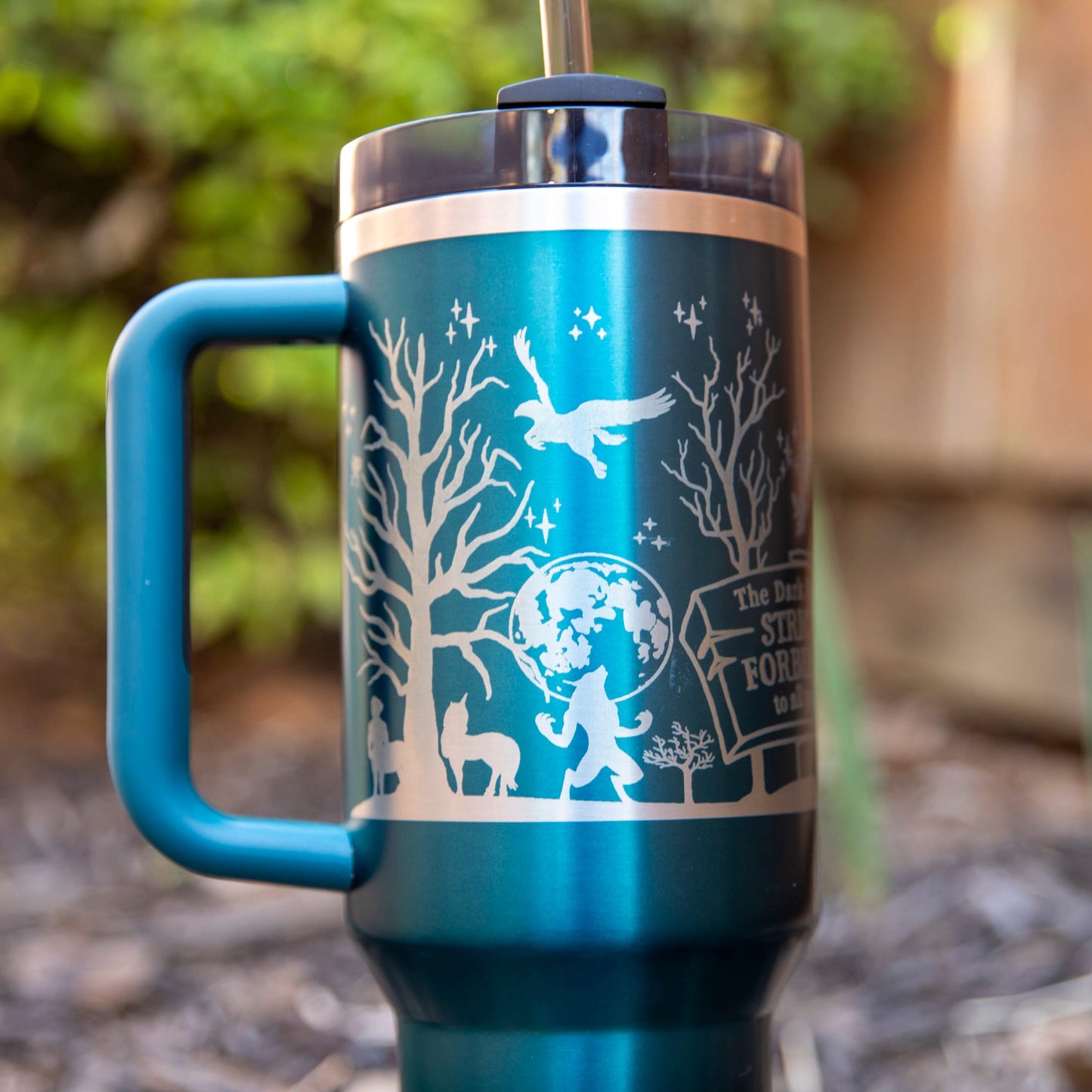 a blue and silver travel mug with a handle