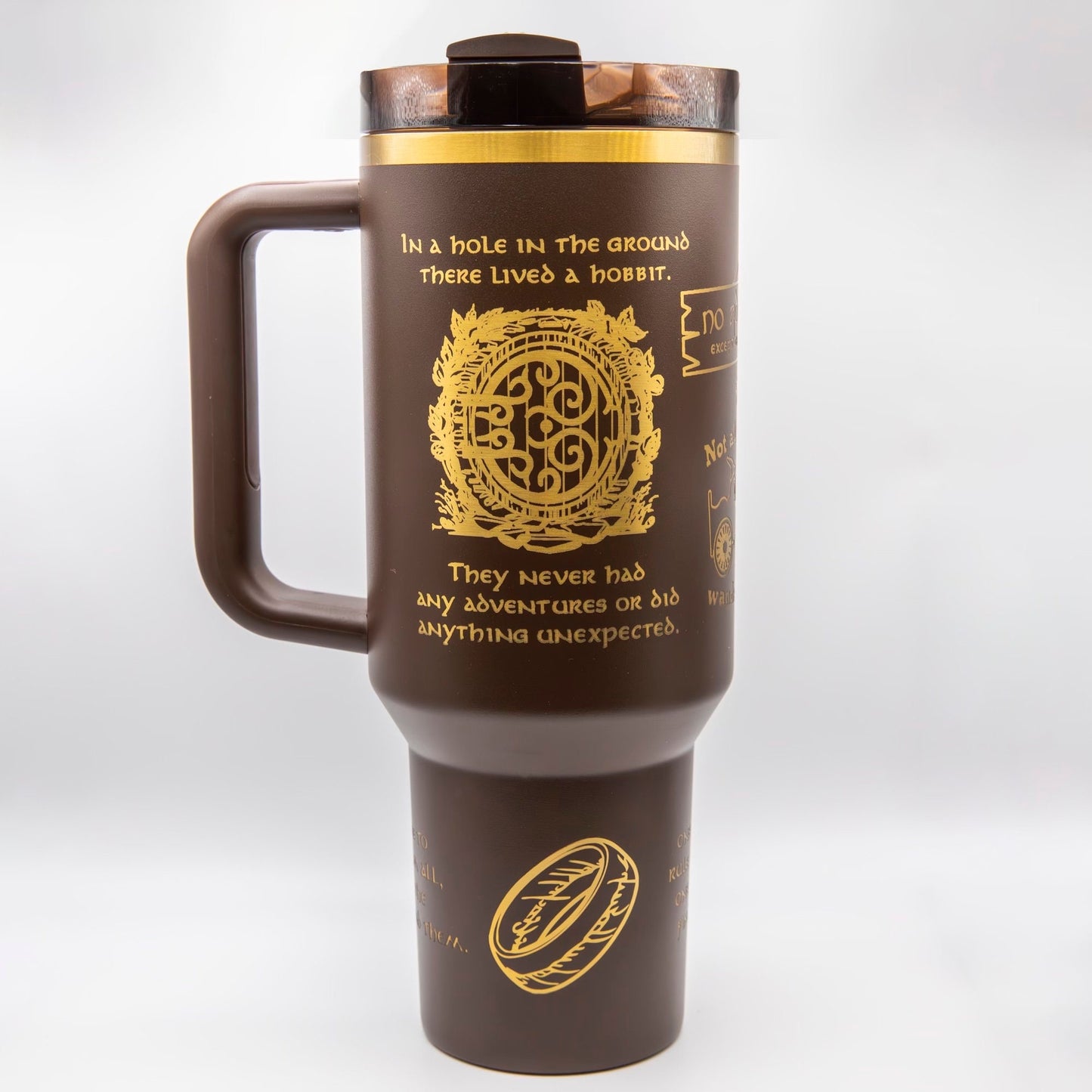 a travel mug with a brown handle and a gold emblem