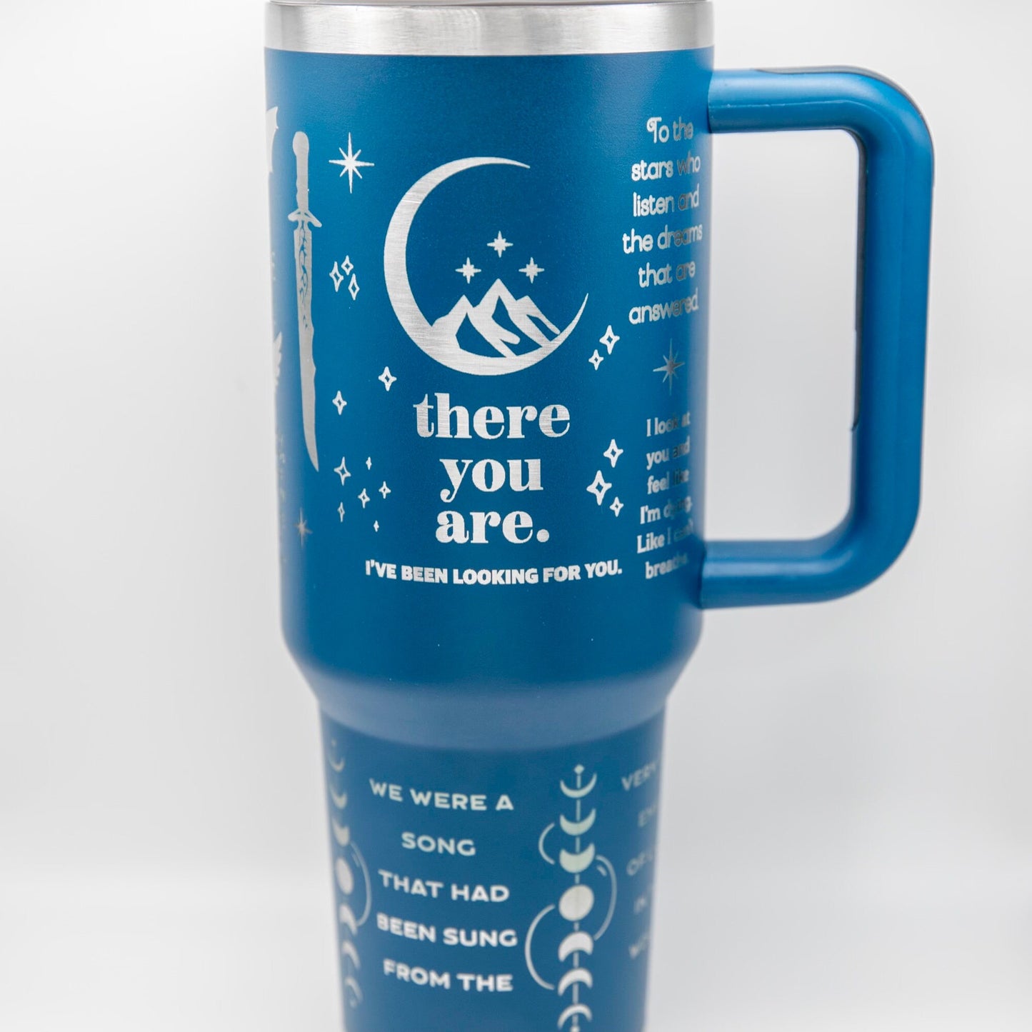 a blue travel mug with the words, there you are