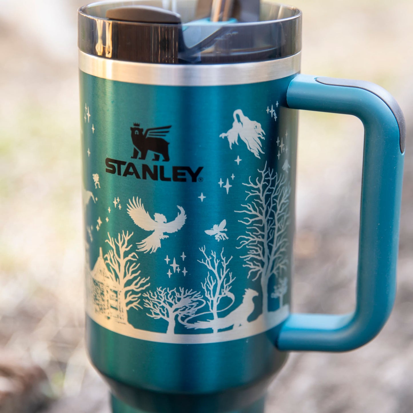 a blue and silver travel mug with a handle