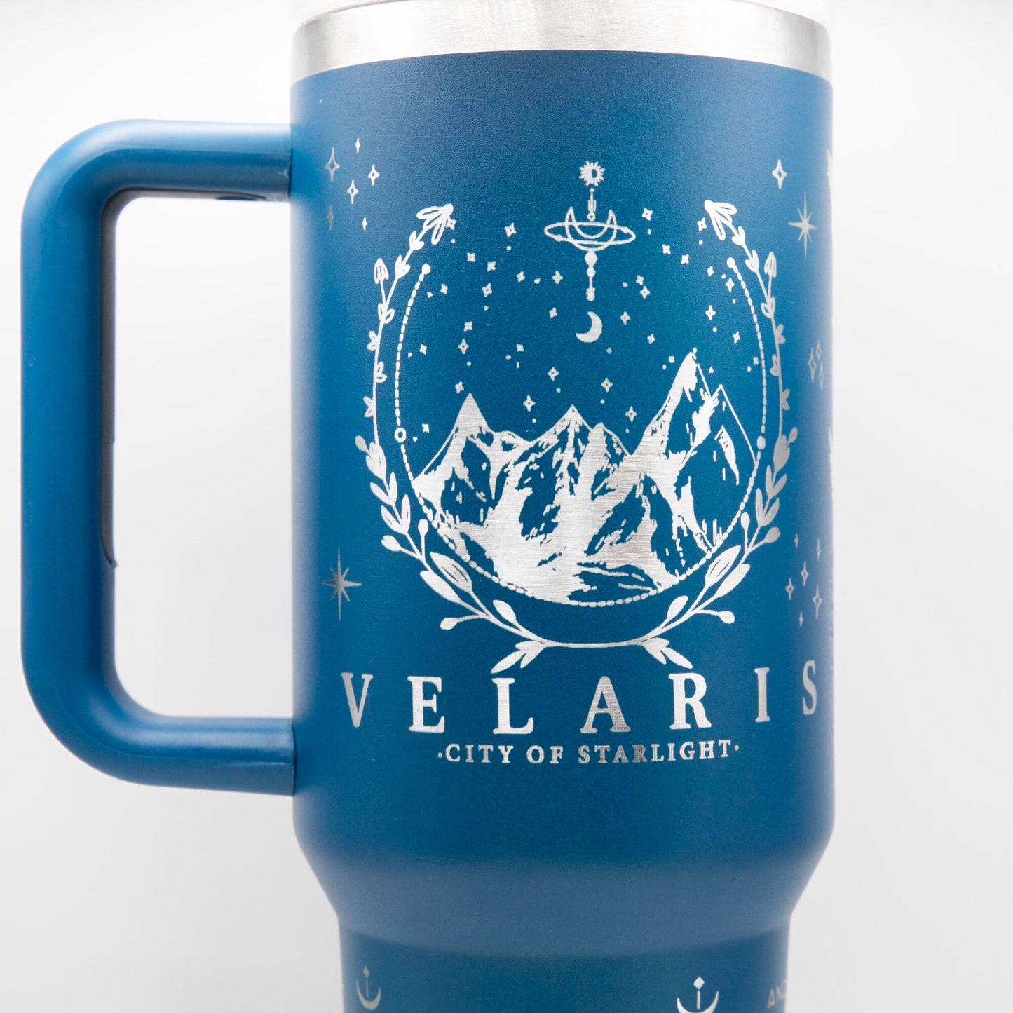 a blue travel mug with a picture of mountains and stars