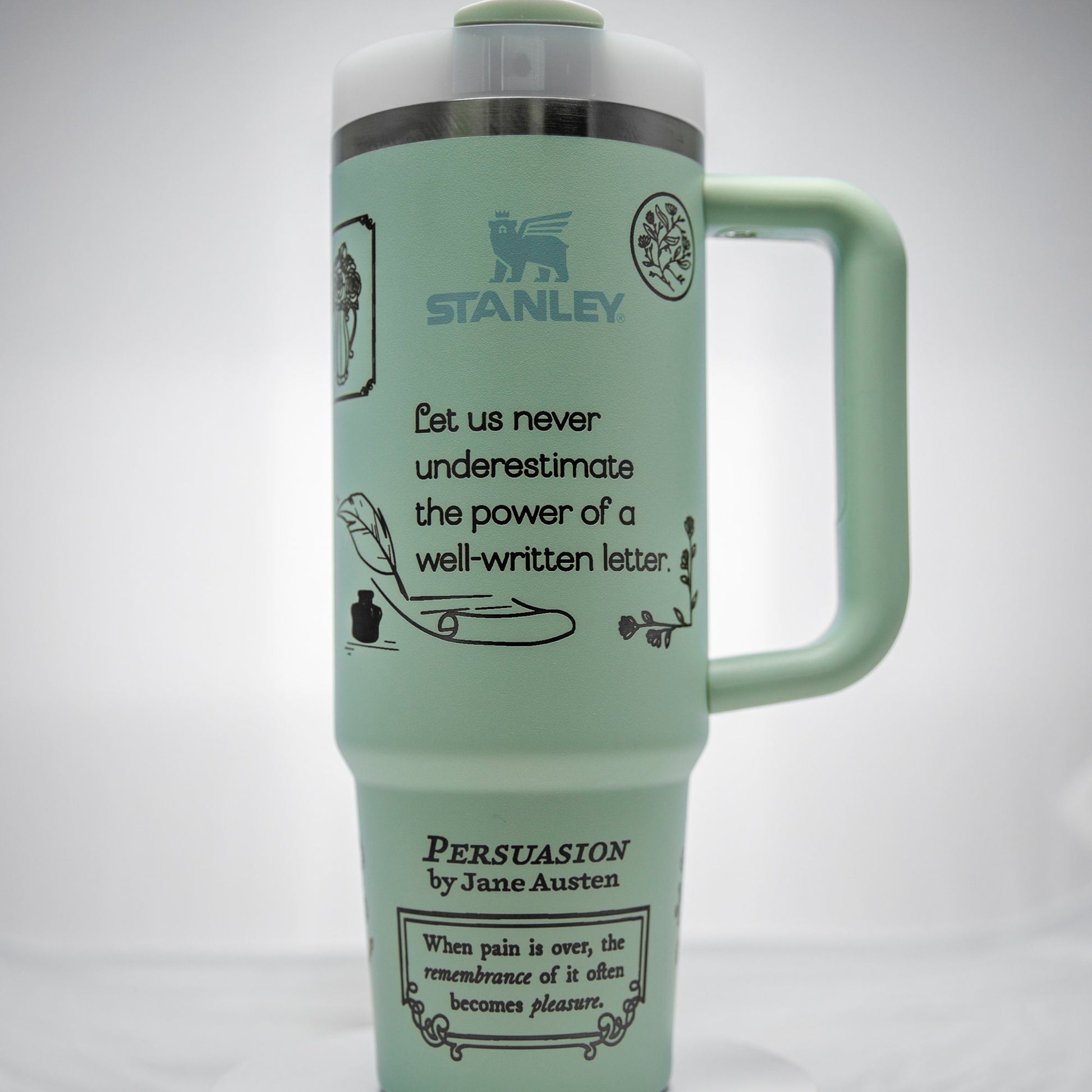 a green travel mug with a picture of a dog on it