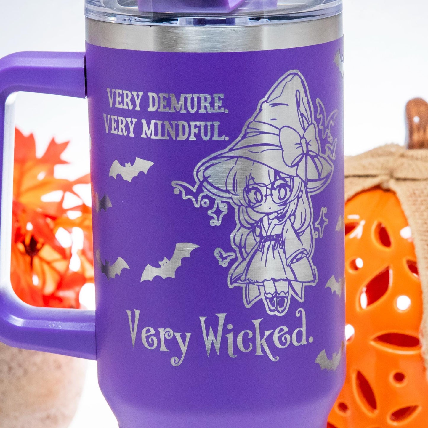 a pair of orange mugs with a witch on them