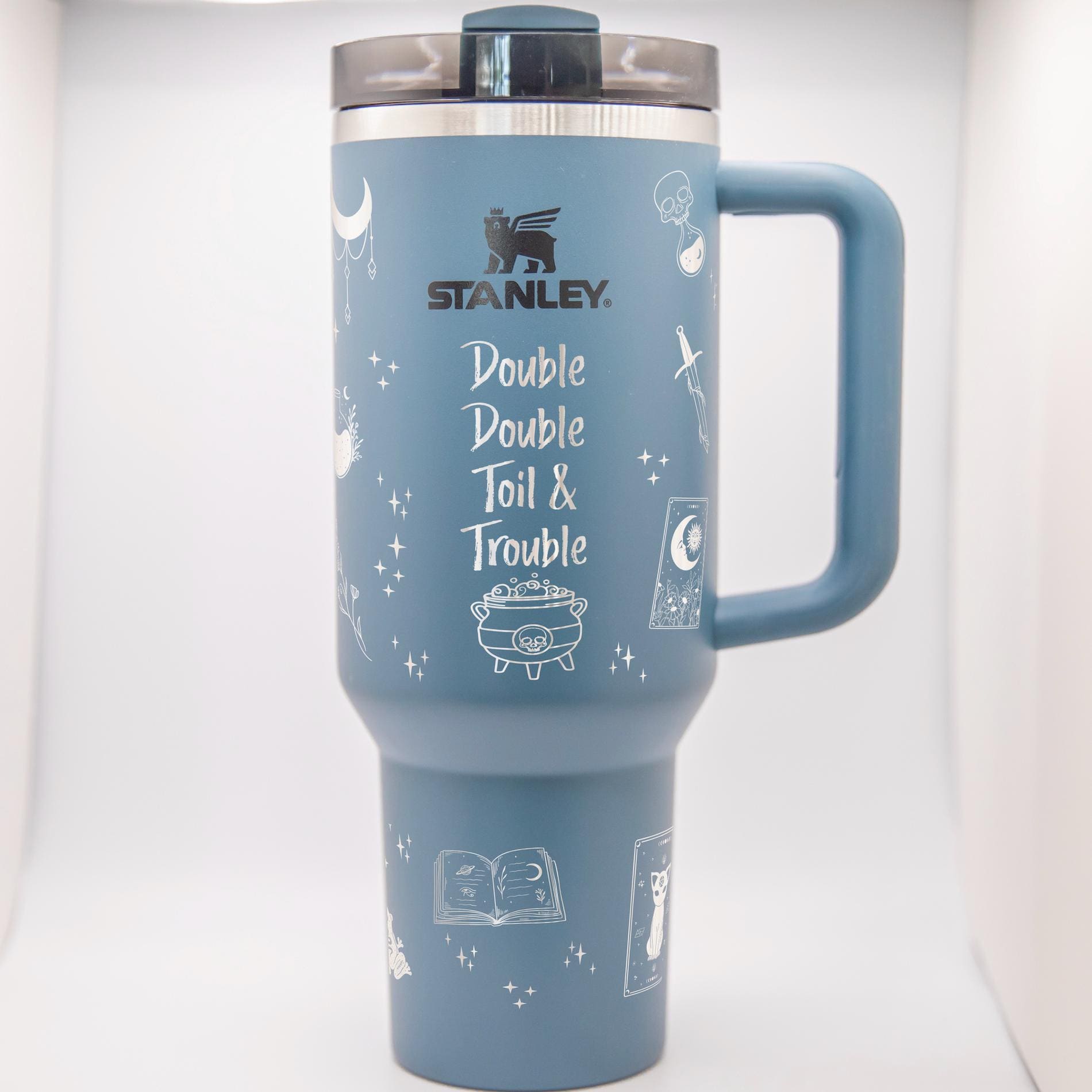 a blue travel mug with a handle on a white background