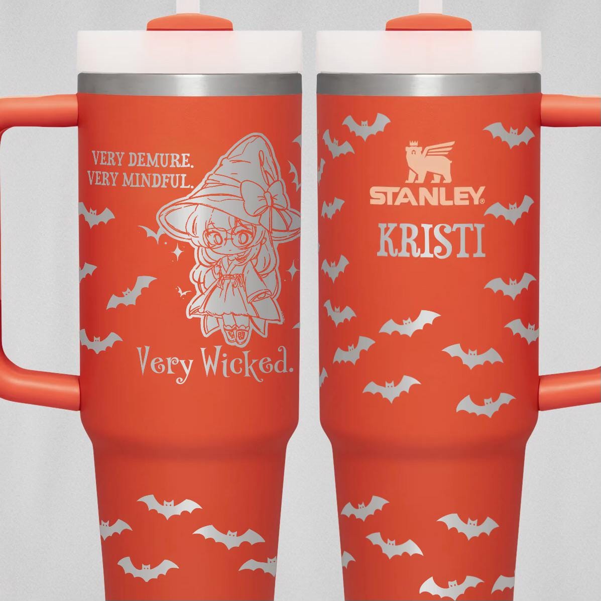 a pair of red coffee mugs with bats on them