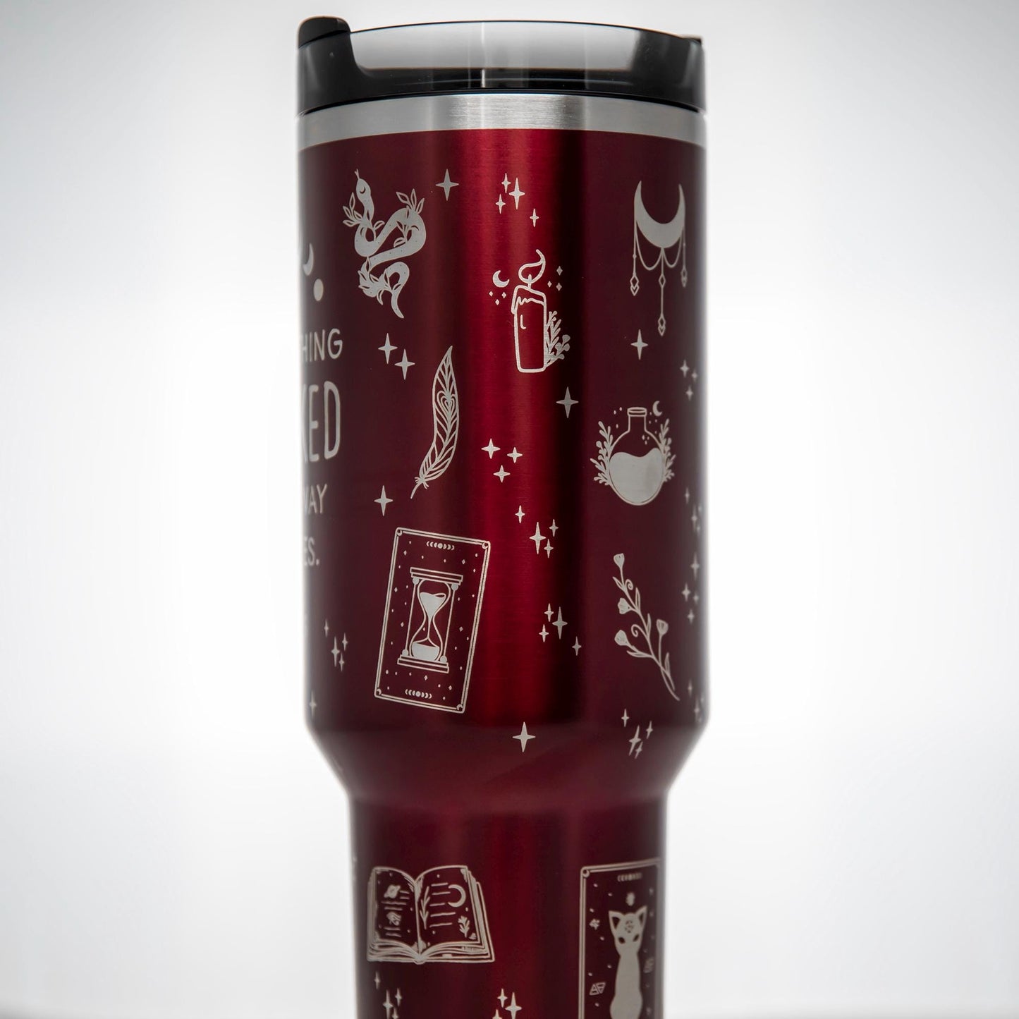 a red travel mug with white drawings on it