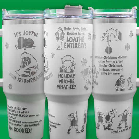 a set of three white cups with cartoon drawings on them